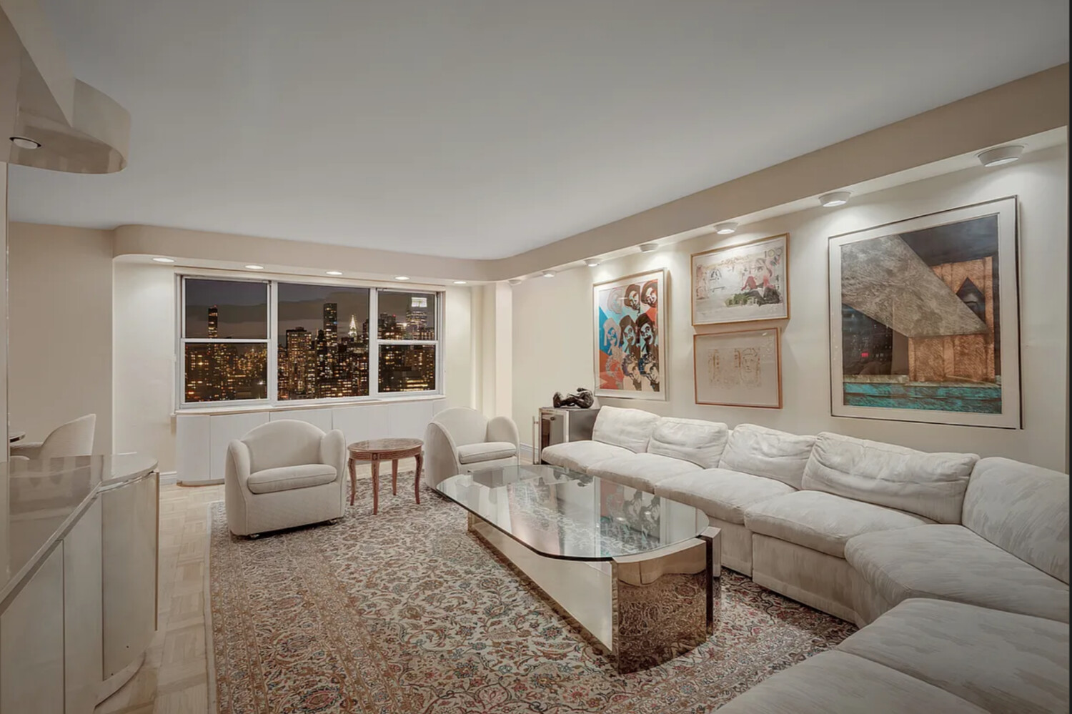 360 East 72nd Street, Unit C3301 Manhattan, NY 10021 - Photo 3 of 27 a living room with furniture and a large window