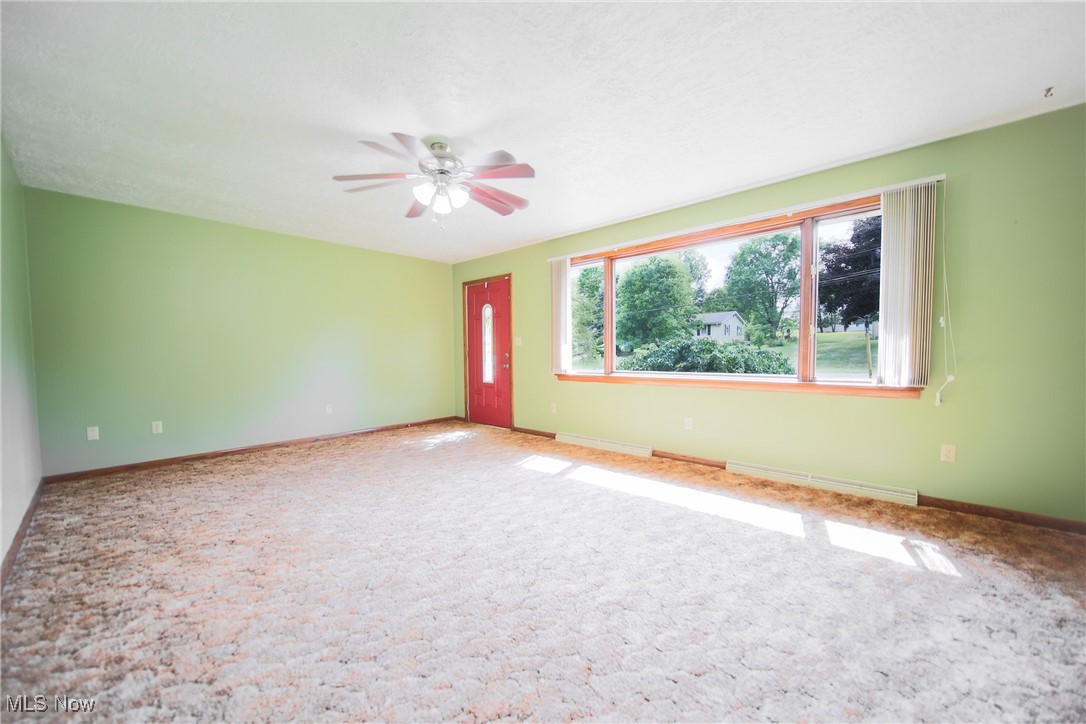 1580 Ruth Drive Wooster, OH 44691 - Photo 14 of 35 Carpeted empty room with a baseboard heating unit and ceiling fan