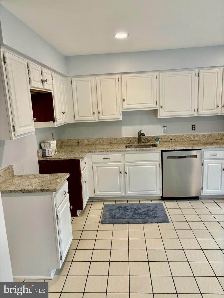 6803 Wild Rose Court Springfield, VA 22152 - Photo 12 of 49 a kitchen with a stove sink and cabinets