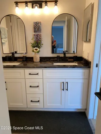 a bathroom with a sink a vanity and a mirror