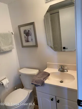 a bathroom with a sink mirror and toilet