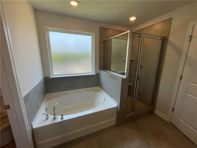 a bathroom with a bathtub and a shower