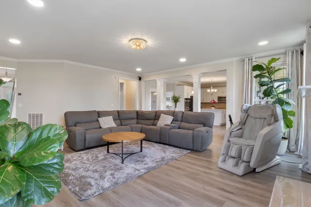 a living room with furniture and a wooden floor