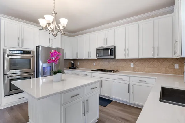 a kitchen with a sink a stove and microwave