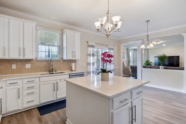 a view of a kitchen center island cabinets and wooden floor