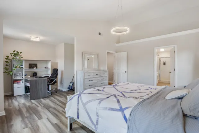 a bathroom with a double vanity sink a large mirror and a bathtub