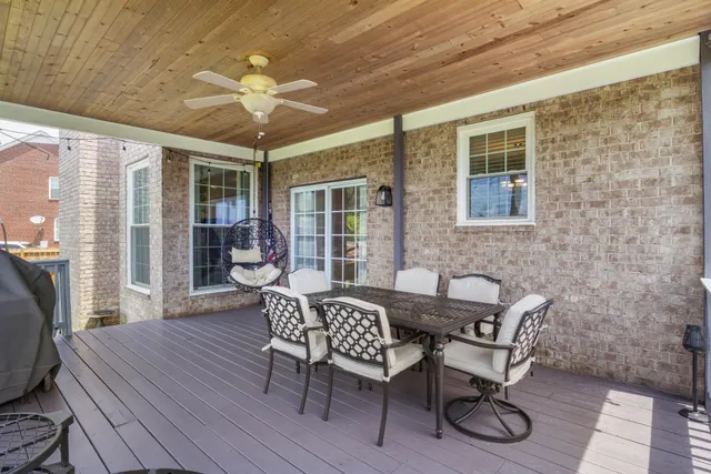 a view of a house with a big yard and large trees