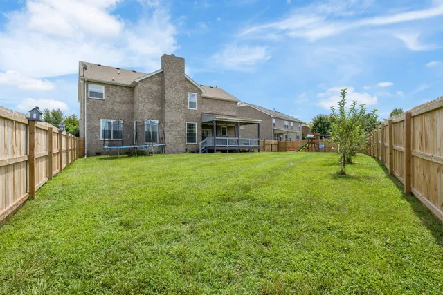 a view of a house with a yard and sitting area