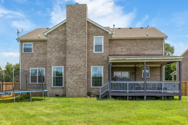 a brick building with a yard in front of it