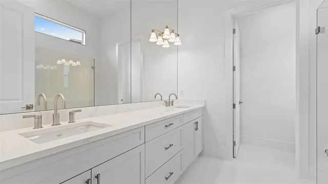 a bathroom with a granite countertop sink a large mirror and shower