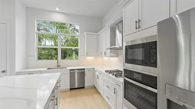 a kitchen with a sink stove and microwave