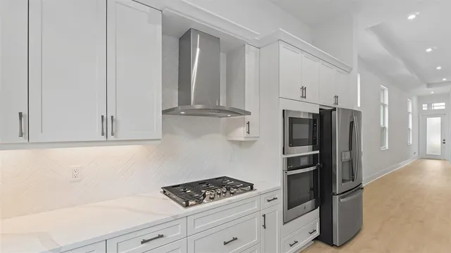 a kitchen with stainless steel appliances a refrigerator and cabinets