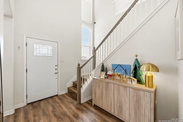 a view of entryway and hall with wooden floor