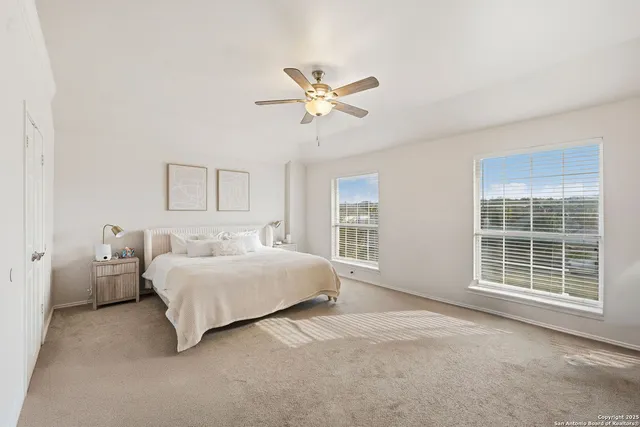 a spacious bedroom with a bed and a large window