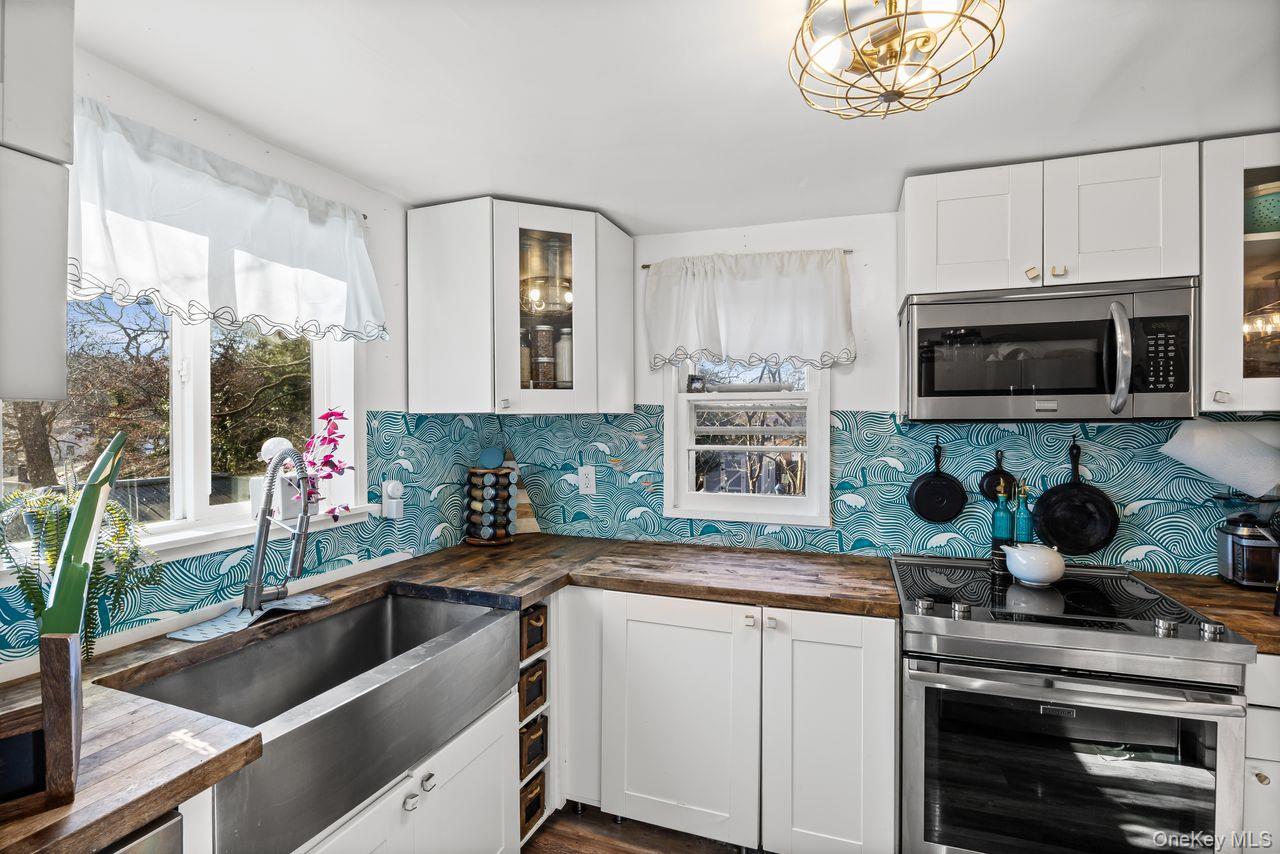 50 Poseidon Road Rocky Point, NY 11778 - Photo 11 of 47 a kitchen with a sink stove and microwave