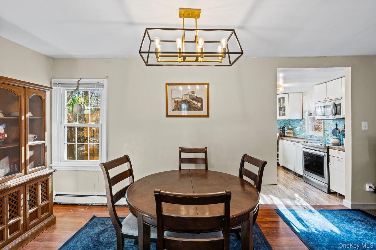 50 Poseidon Road Rocky Point, NY 11778 - Photo 13 of 47 a view of a dining room with furniture window and wooden floor