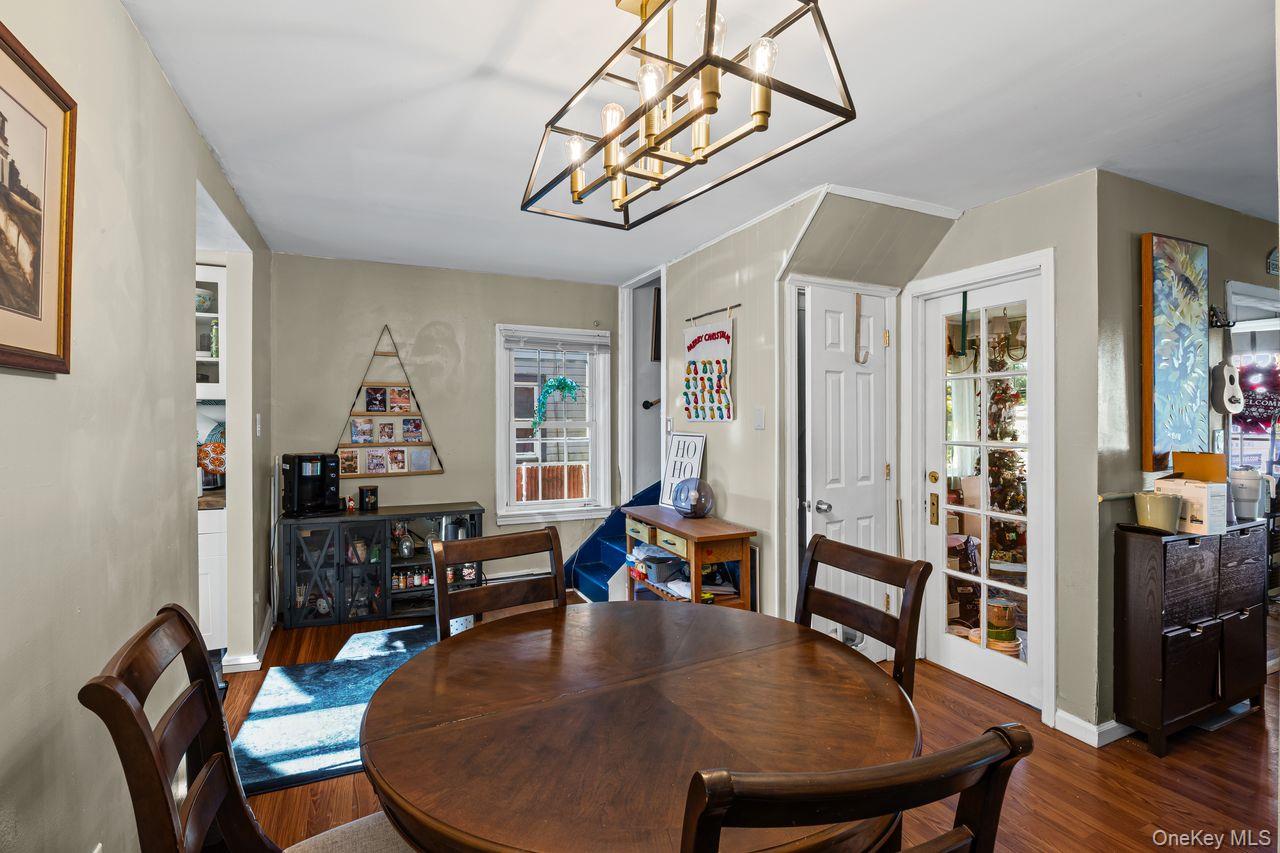 50 Poseidon Road Rocky Point, NY 11778 - Photo 15 of 47 a dining room with furniture a rug a potted plant and wooden floor