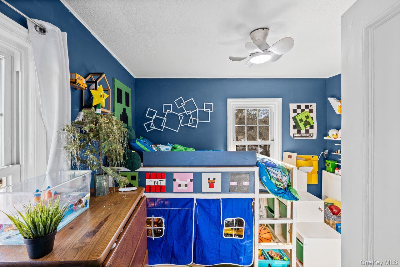 50 Poseidon Road Rocky Point, NY 11778 - Photo 17 of 47 a room with furniture and potted plant