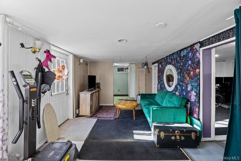 50 Poseidon Road Rocky Point, NY 11778 - Photo 25 of 47 a living room with furniture a window and gym equipment