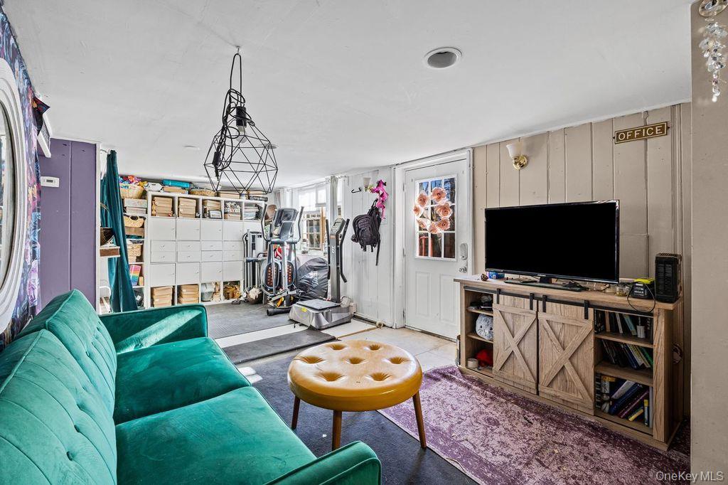 50 Poseidon Road Rocky Point, NY 11778 - Photo 26 of 47 a living room with furniture and a flat screen tv