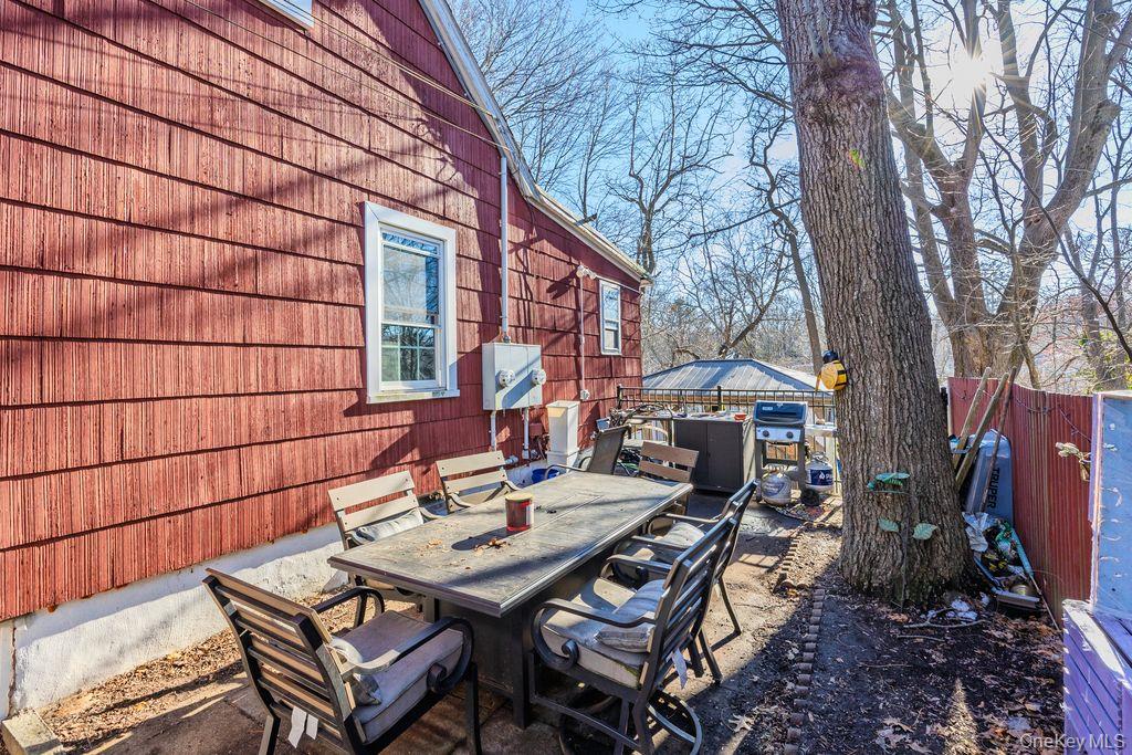 50 Poseidon Road Rocky Point, NY 11778 - Photo 32 of 47 a backyard of a house with table and chairs