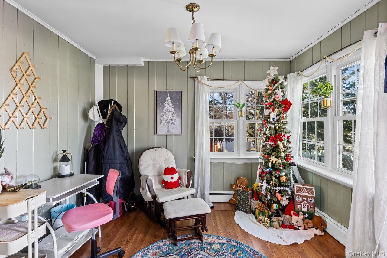 50 Poseidon Road Rocky Point, NY 11778 - Photo 4 of 47 a living room with furniture a chandelier and a window