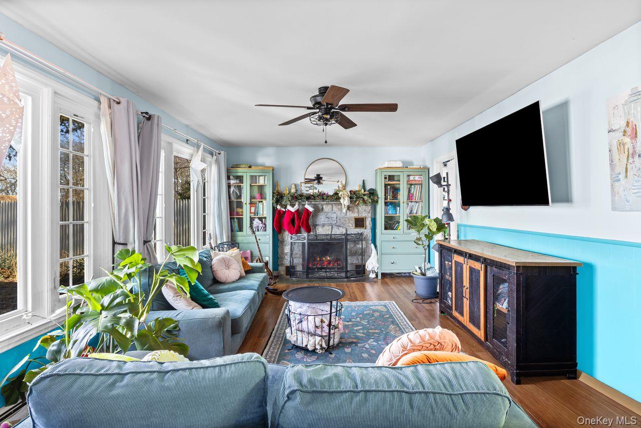 50 Poseidon Road Rocky Point, NY 11778 - Photo 5 of 47 a living room with furniture and a flat screen tv