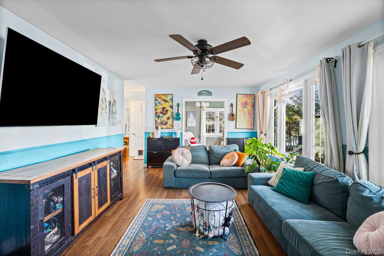 50 Poseidon Road Rocky Point, NY 11778 - Photo 7 of 47 a living room with furniture and a flat screen tv