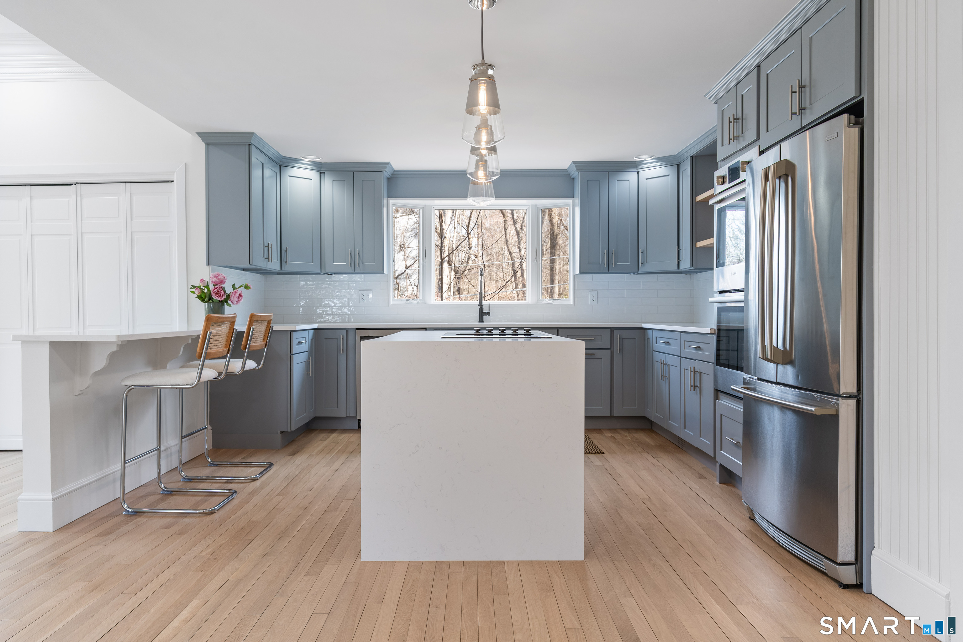 14 Windermere Lane Stamford, CT 06902 - Photo 12 of 45 a kitchen with kitchen island a sink a center island stainless steel appliances and cabinets