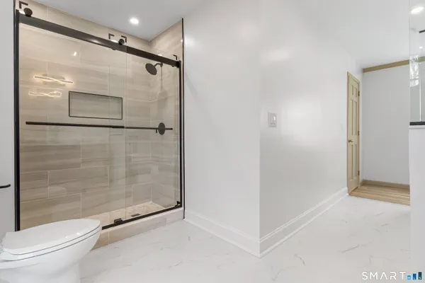 a bathroom with a glass shower door