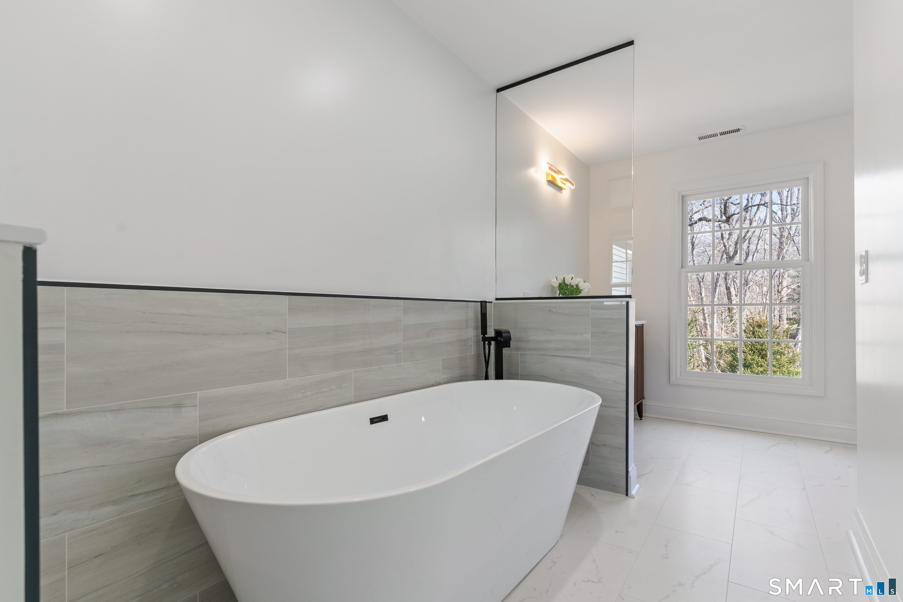 14 Windermere Lane Stamford, CT 06902 - Photo 24 of 45 a bathroom with a bathtub and window