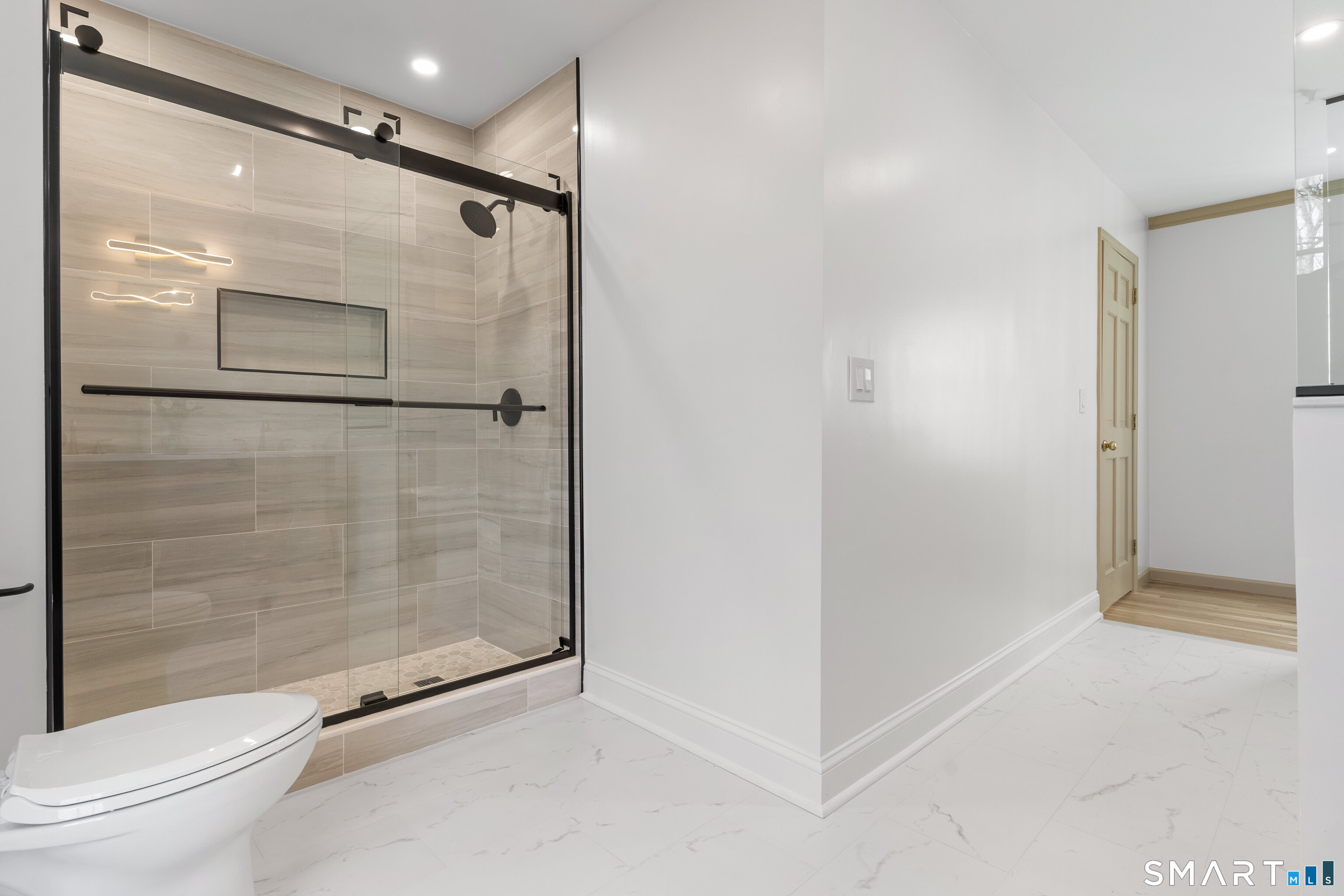 14 Windermere Lane Stamford, CT 06902 - Photo 26 of 45 a bathroom with a glass shower door