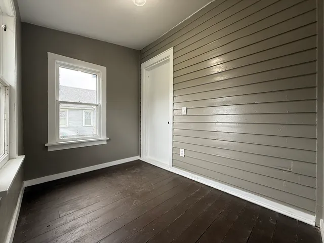 a view of room with window and wooden floor