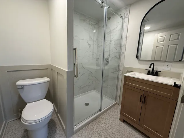 a bathroom with a sink toilet and shower