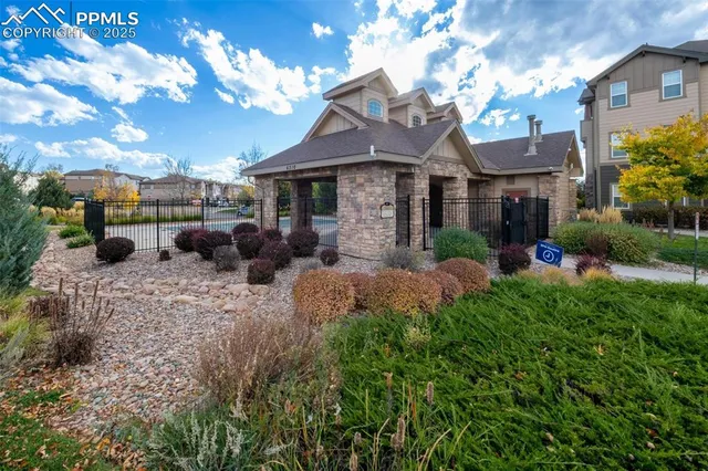 a view of a house with a yard and a garden