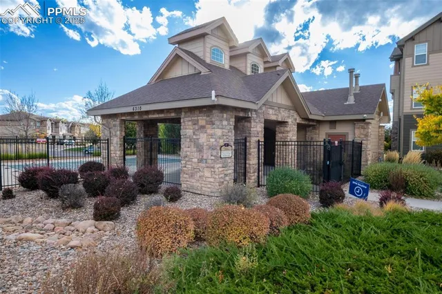 a view of a chairs and table in backyard