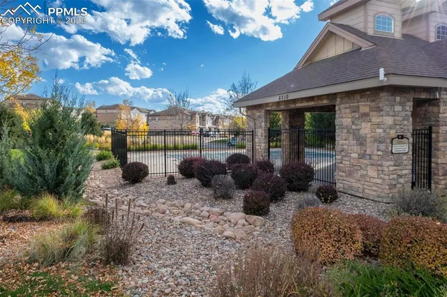 a view of a patio with table and chairs and potted plants