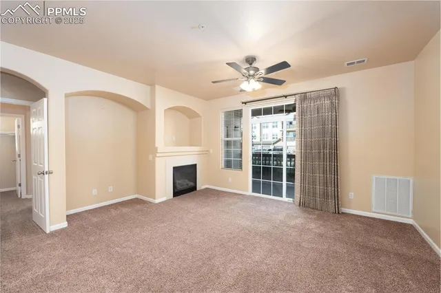 a living room with furniture fireplace and a large window
