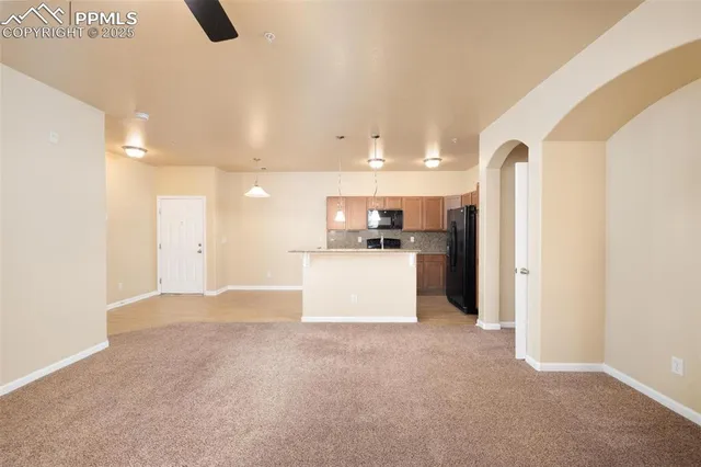 a kitchen with granite countertop a sink stainless steel appliances and cabinets