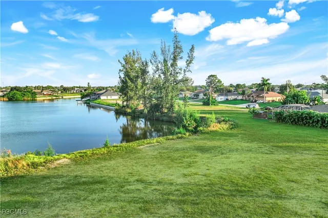 a yard with swimming pool and green space