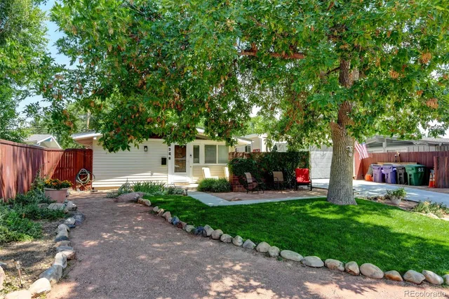 a front view of a house with swing and garden