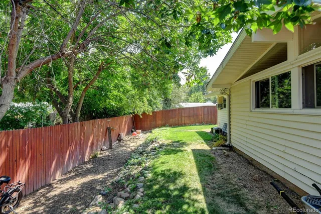 a view of small yard with wooden fence