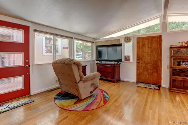 a living room with furniture windows and a flat screen tv
