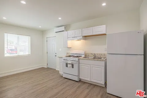 a kitchen with stainless steel appliances granite countertop a stove and a refrigerator
