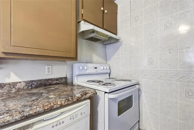 a kitchen with a stove and a microwave