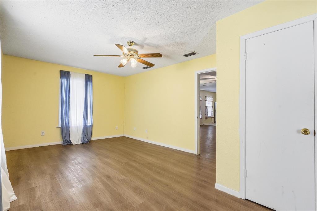 3822 Ragged Rock Court Joshua, TX 76058 - Photo 17 of 34 an empty room with wooden floor and a ceiling fan