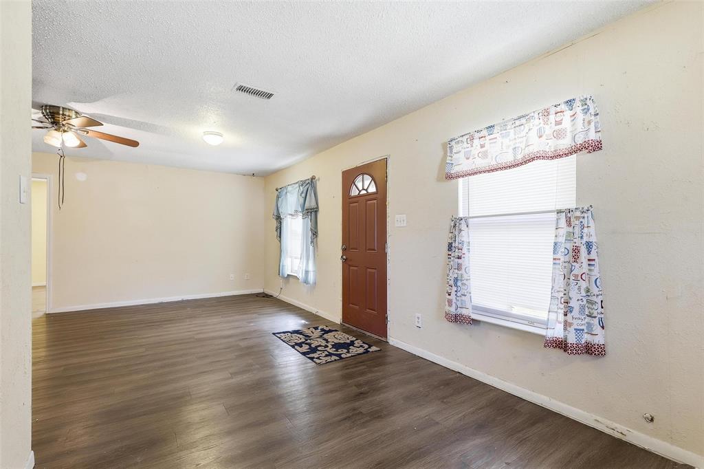 3822 Ragged Rock Court Joshua, TX 76058 - Photo 2 of 34 an empty room with wooden floor cabinet and windows