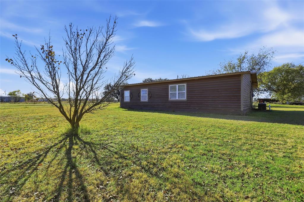 3822 Ragged Rock Court Joshua, TX 76058 - Photo 22 of 34 a view of a backyard with a large tree
