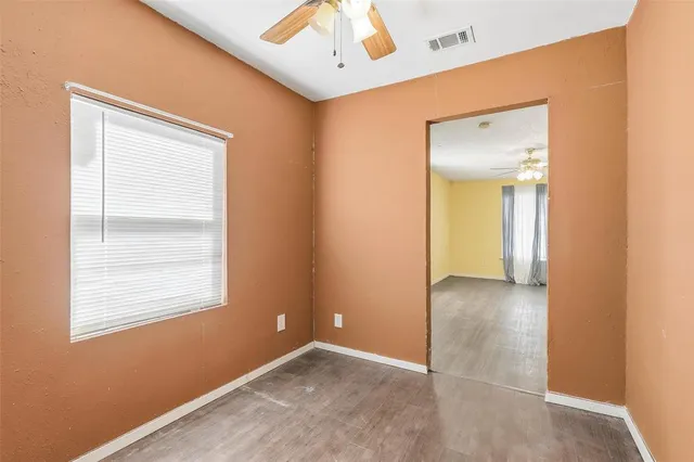 an empty room with windows and closet