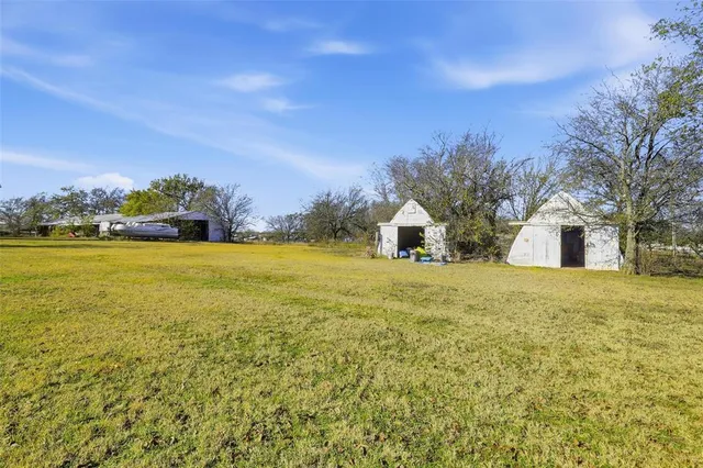 a view of a house with yard and ocean view